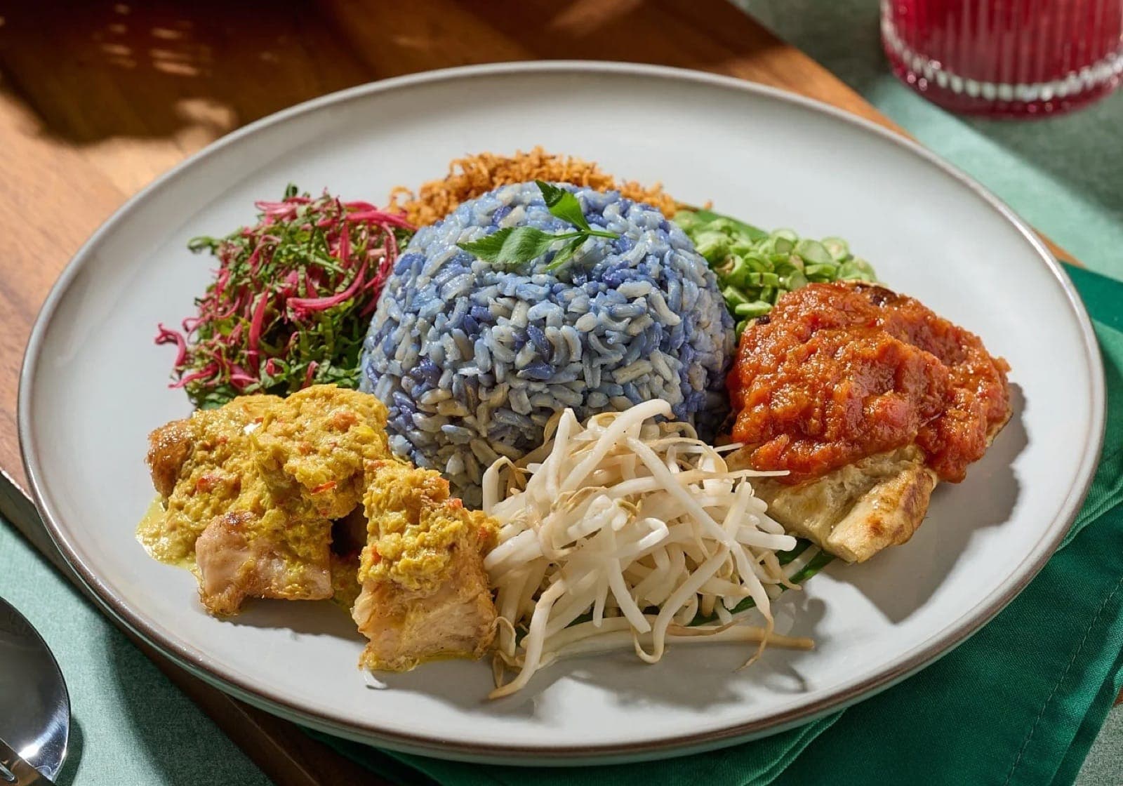 Nasi kerabu with blue rice and sambal